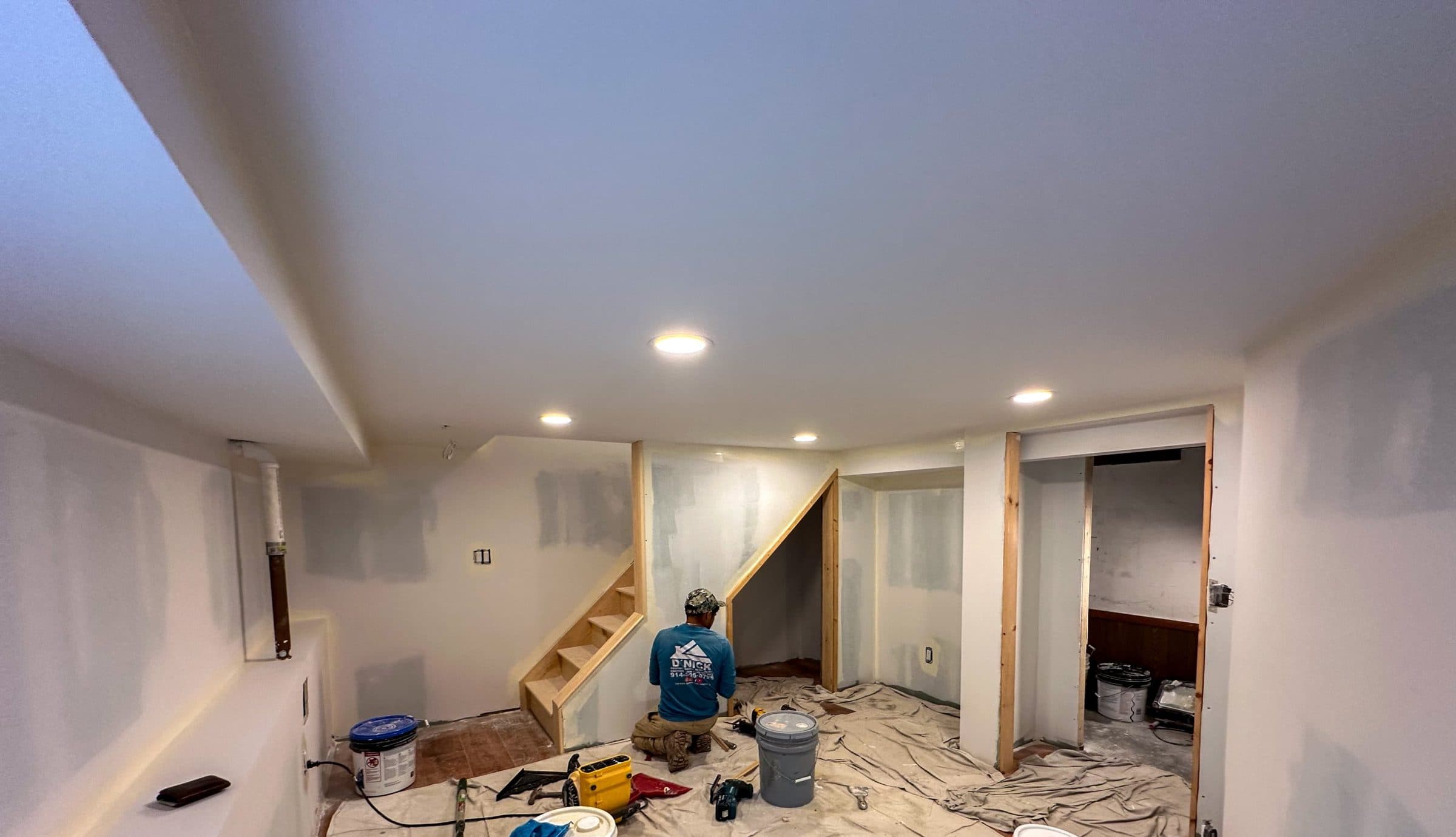 Our crew finishing a basement: drywall, new stairs and recessed lights